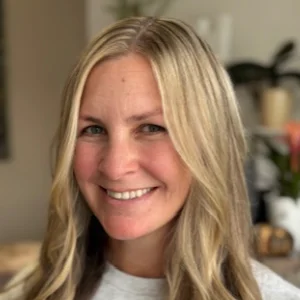 Smiling blonde woman indoors with blurred background